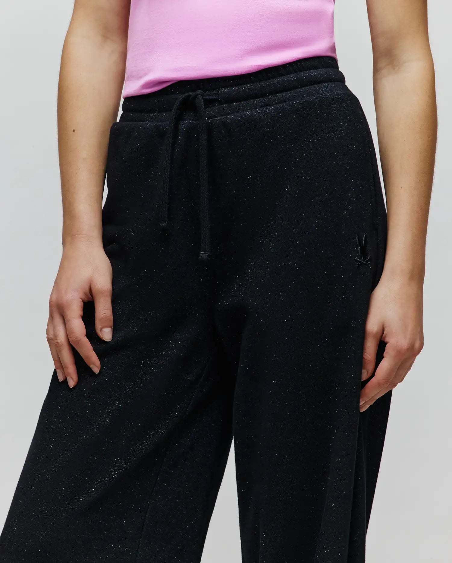 Womens Jules Lurex Sweatpant, black relaxed fit with subtle silver lurex sparkle, featuring a drawstring waist and a small tonal embroidered Psycho Bunny skull logo on the right hip.