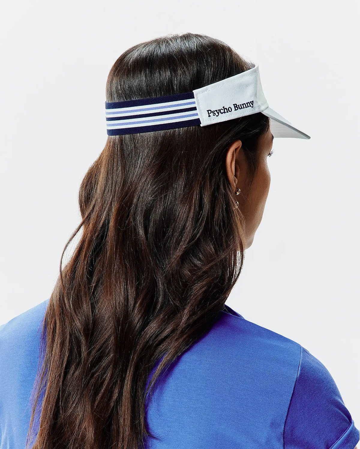 Women's Sport Visor featuring a crisp white brim, a navy blue elastic band with prominent light blue and white stripes, and an embroidered Psycho Bunny text logo on the front panel. (3)