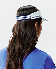 Women's Sport Visor featuring a crisp white brim, a navy blue elastic band with prominent light blue and white stripes, and an embroidered Psycho Bunny text logo on the front panel. (3)