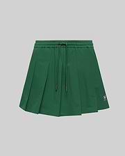 WOMEN'S CECILIA PLEATED SKORT in dark green, featuring an elastic drawstring waist, a relaxed A-line fit with crisp pleats, and a small embroidered pink Psycho Bunny skull logo on the lower right hem. (5)