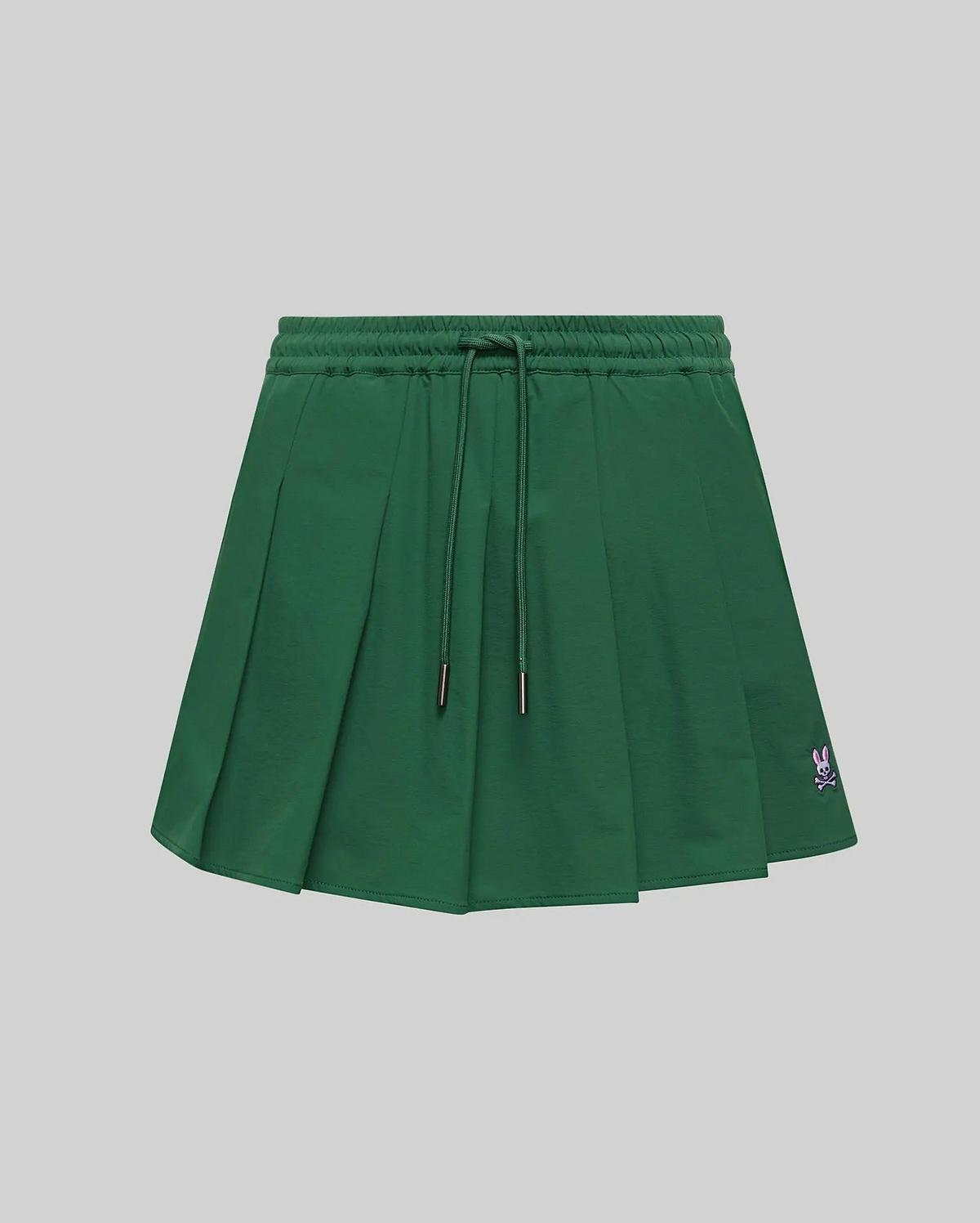 WOMEN'S CECILIA PLEATED SKORT in dark green, featuring an elastic drawstring waist, a relaxed A-line fit with crisp pleats, and a small embroidered pink Psycho Bunny skull logo on the lower right hem. (5)