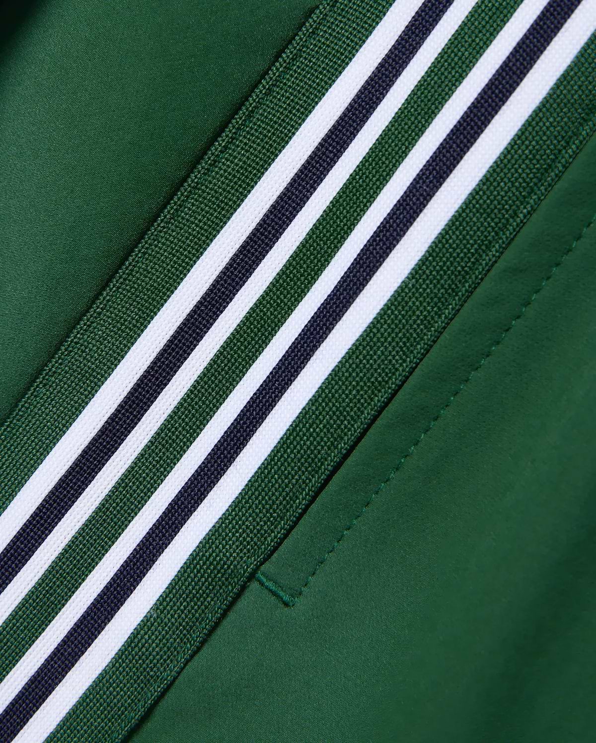 Women's Cecilia Pleated Skort in deep green, featuring a diagonal woven stripe with white, dark green, and navy blue bands on smooth performance fabric. (6)