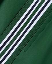 Women's Cecilia Pleated Skort in deep green, featuring a diagonal woven stripe with white, dark green, and navy blue bands on smooth performance fabric. (6)