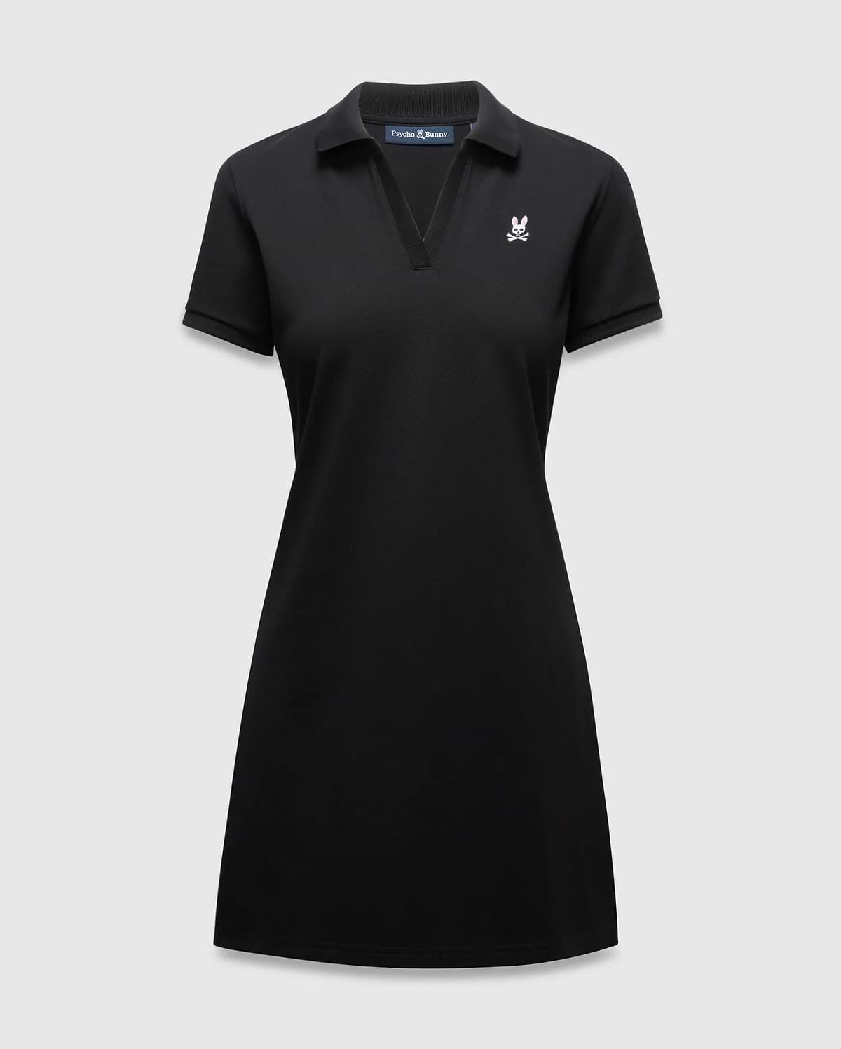 Women's Clara Pique Dress, black classic fit pique dress with a polo collar, V-neck, short sleeves, and a small white and pink embroidered Psycho Bunny skull logo on the left chest.