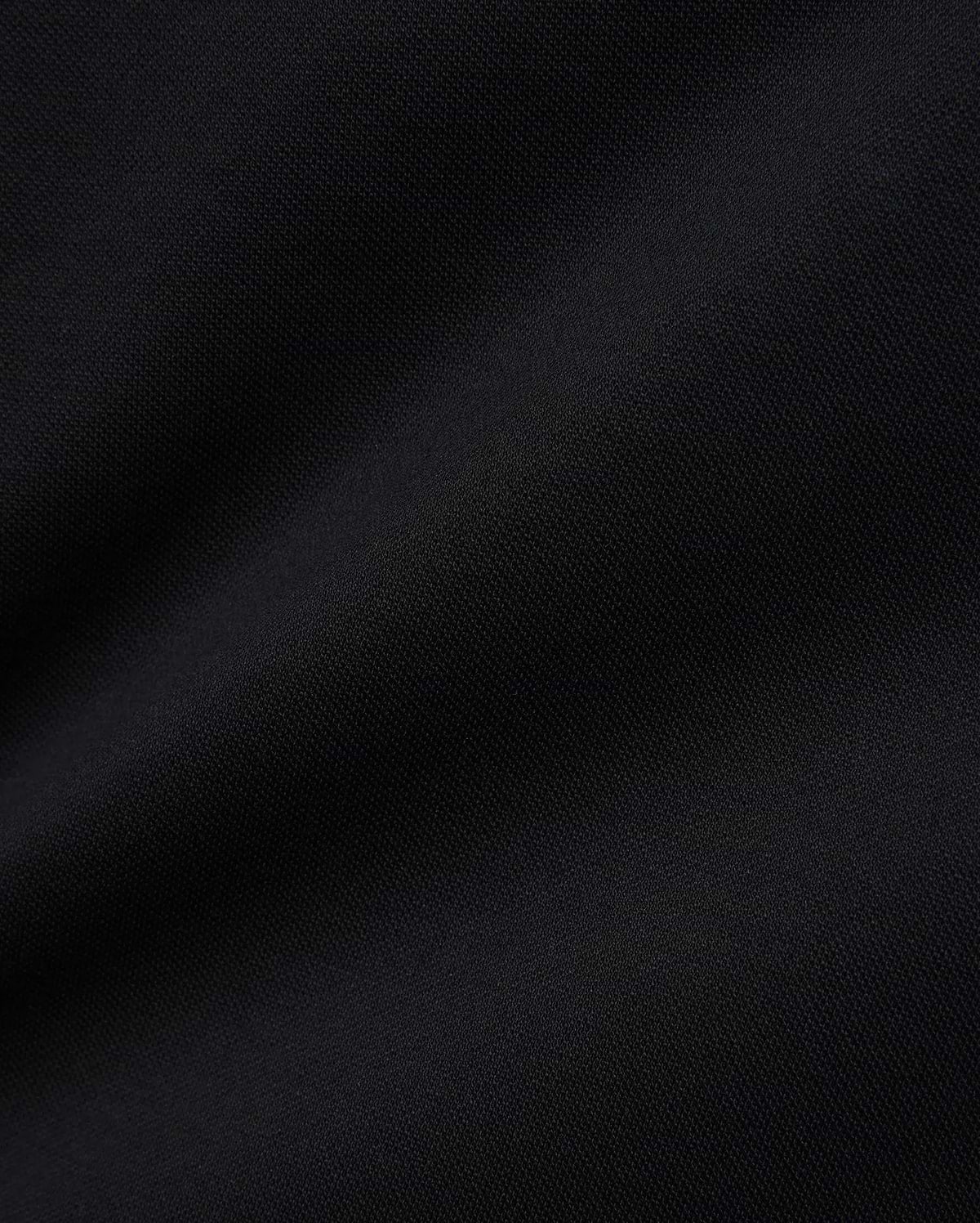 Women's Clara Pique Dress in rich, solid black, highlighting the premium, breathable pique knit fabric with its subtle, textured weave, reflecting Psycho Bunny's refined streetwear aesthetic.