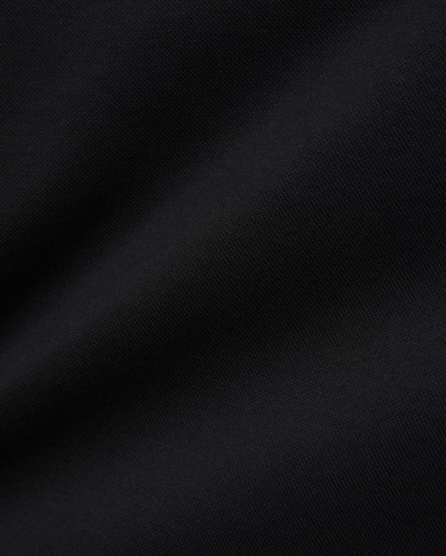 Women's Clara Pique Dress in rich, solid black, highlighting the premium, breathable pique knit fabric with its subtle, textured weave, reflecting Psycho Bunny's refined streetwear aesthetic.