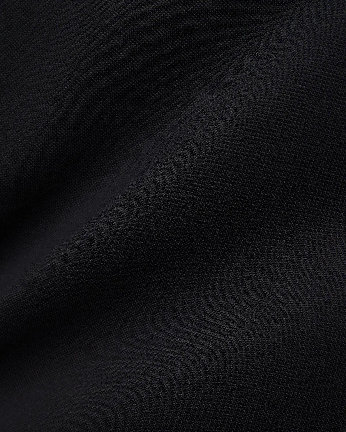 Women's Clara Pique Dress in rich, solid black, highlighting the premium, breathable pique knit fabric with its subtle, textured weave, reflecting Psycho Bunny's refined streetwear aesthetic.