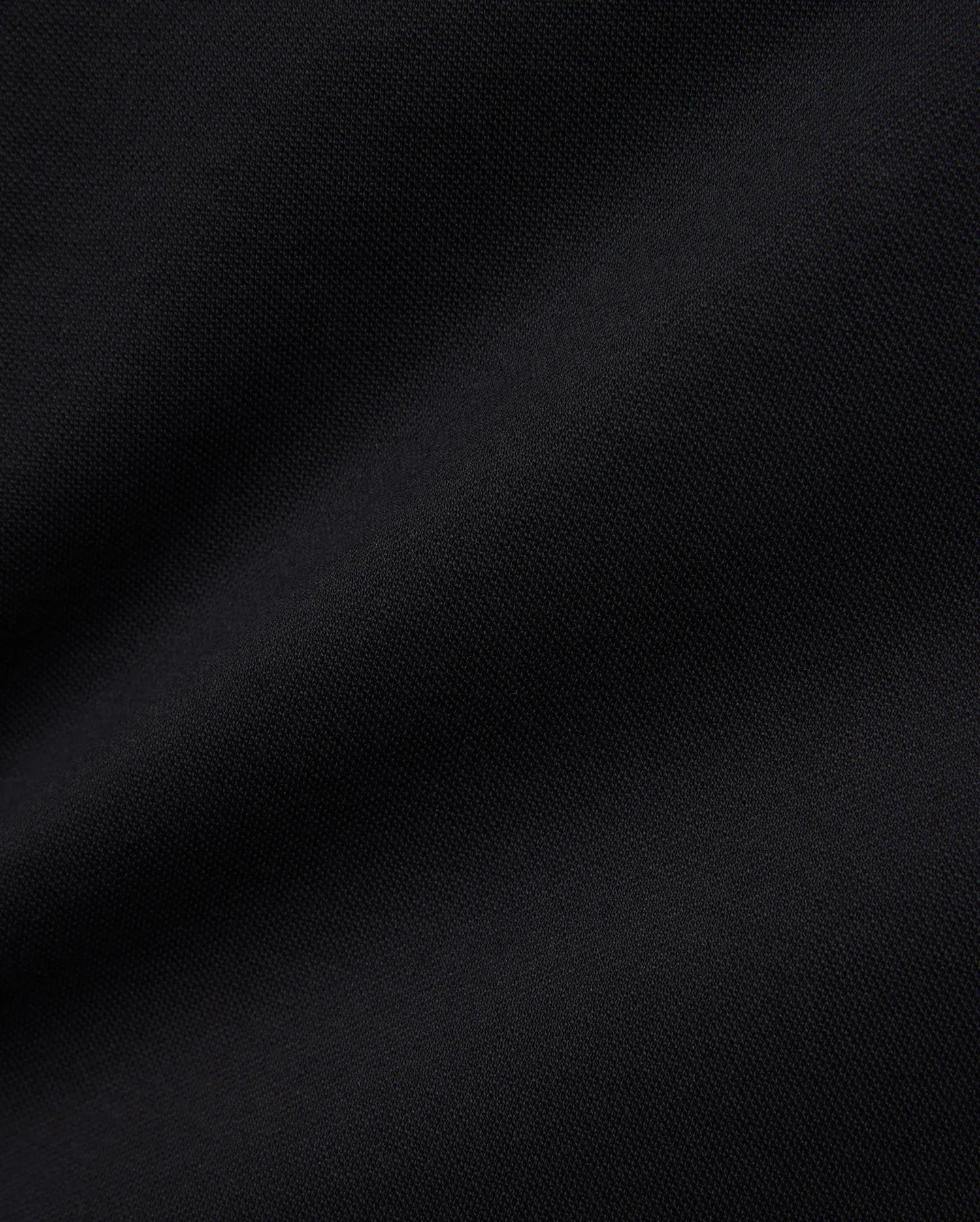 Women's Clara Pique Dress in rich, solid black, highlighting the premium, breathable pique knit fabric with its subtle, textured weave, reflecting Psycho Bunny's refined streetwear aesthetic.