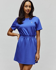 Womens Penelope Dress in royal blue jersey knit, featuring a relaxed fit, elasticated waist, and a small white, black, and pink embroidered Psycho Bunny skull logo on the left chest.