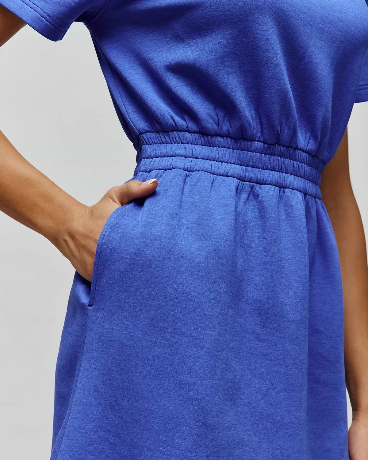 Womens Penelope Dress in vibrant royal blue soft jersey knit, featuring short sleeves, a relaxed fit, elasticated waist, and practical side pockets.