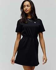Womens Penelope Dress: Black short-sleeve jersey dress with a relaxed fit, crew neck, elasticated waist, side pockets, and a small embroidered white Psycho Bunny skull logo on the left chest.