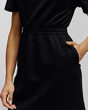 Womens Penelope Dress, a classic black short-sleeved jersey dress offering a comfortable relaxed fit, with a stylish elasticated ruched waistband and convenient side pockets.