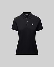The Psycho Bunny WOMENS PIQUE POLO - WT0100003 is a black short-sleeve women's polo with a collar, three white buttons, and a small 4k-stitch embroidered Bunny logo on the left chest, shown on a plain gray background.
