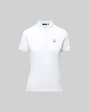 The WOMENS PIQUE POLO - WT0100003 by Psycho Bunny is a white short-sleeve polo featuring a collar, button placket, and 4k-stitch embroidered Bunny logo on the left chest, shown on a plain gray background.