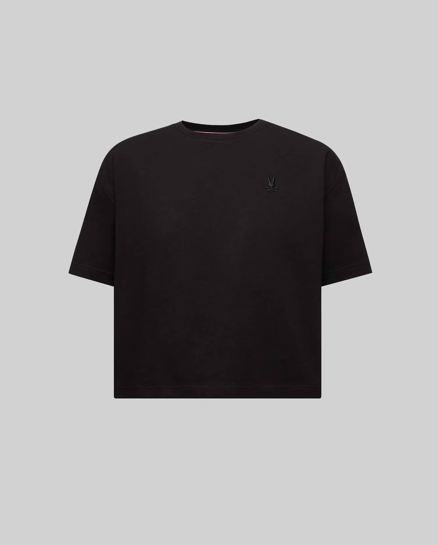Women's Camille Oversized Fit Tee, a black oversized jersey knit t-shirt featuring a small embroidered black Psycho Bunny skull logo on the left chest and pink neck tape.