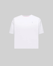 Women's Camille Oversized Fit Tee, premium white jersey with a small embroidered silver-blue Psycho Bunny skull logo on the left chest and a pink inner neckline.