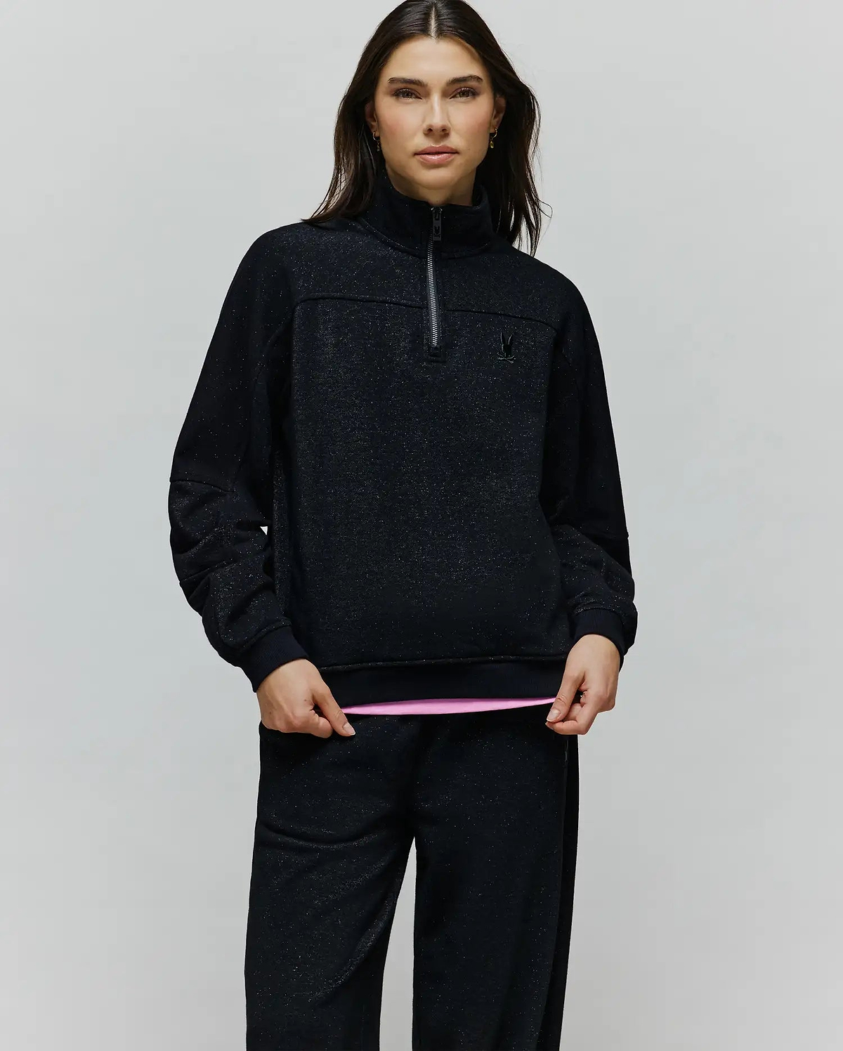 Womens Jules Lurex 1/4 Zip Pullover in black lurex knit with subtle silver sparkle, featuring a relaxed fit, high collar, 1/4 zip, and small embroidered black Psycho Bunny skull logo on the left chest.