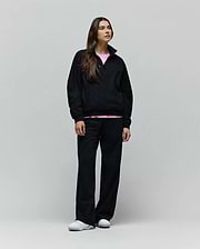 Womens Jules Lurex 1/4 Zip Pullover in black lurex knit, featuring a relaxed fit, small embroidered Psycho Bunny skull logo on the left chest, and a visible pink undershirt.