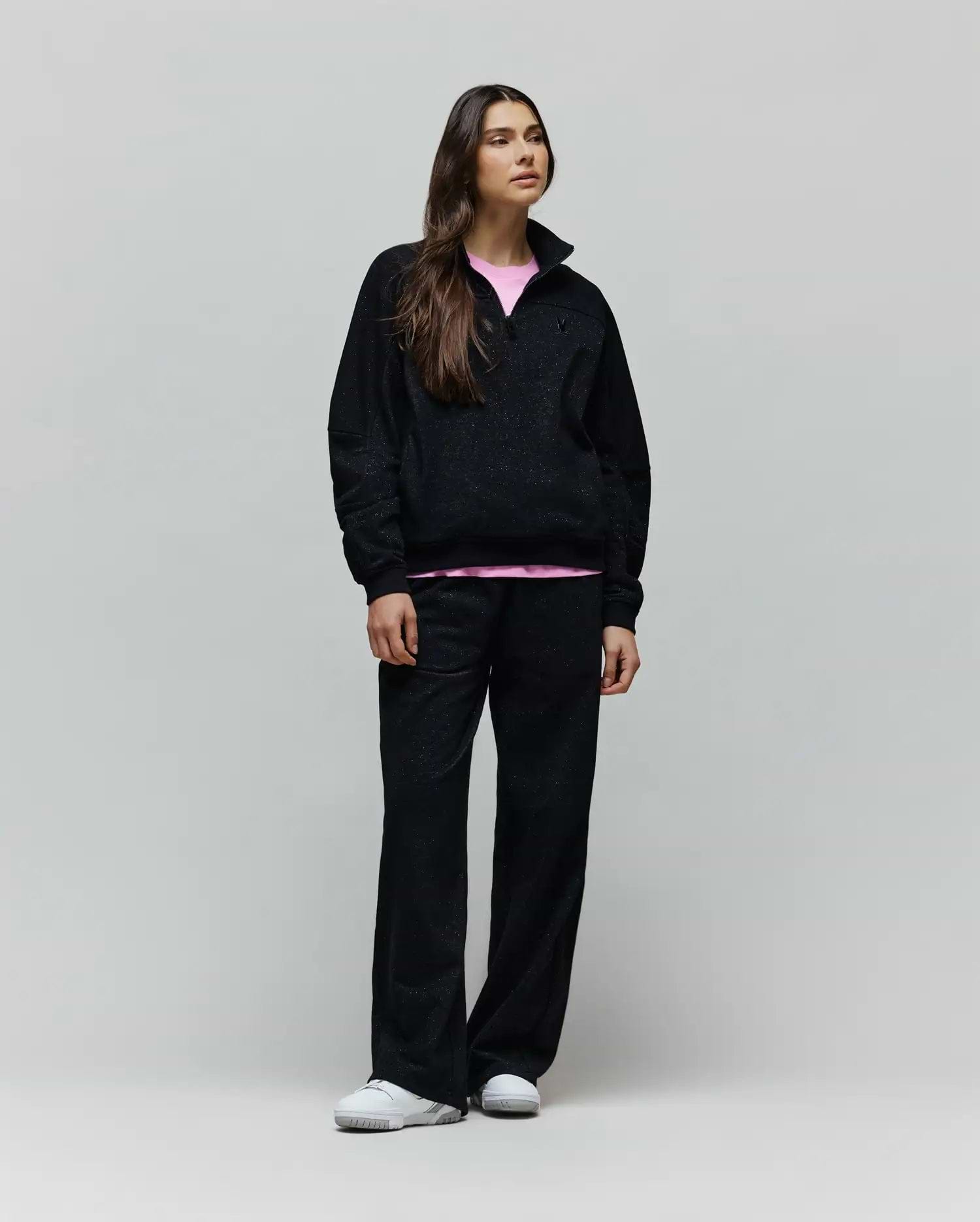 Womens Jules Lurex 1/4 Zip Pullover in black lurex knit, featuring a relaxed fit, small embroidered Psycho Bunny skull logo on the left chest, and a visible pink undershirt.