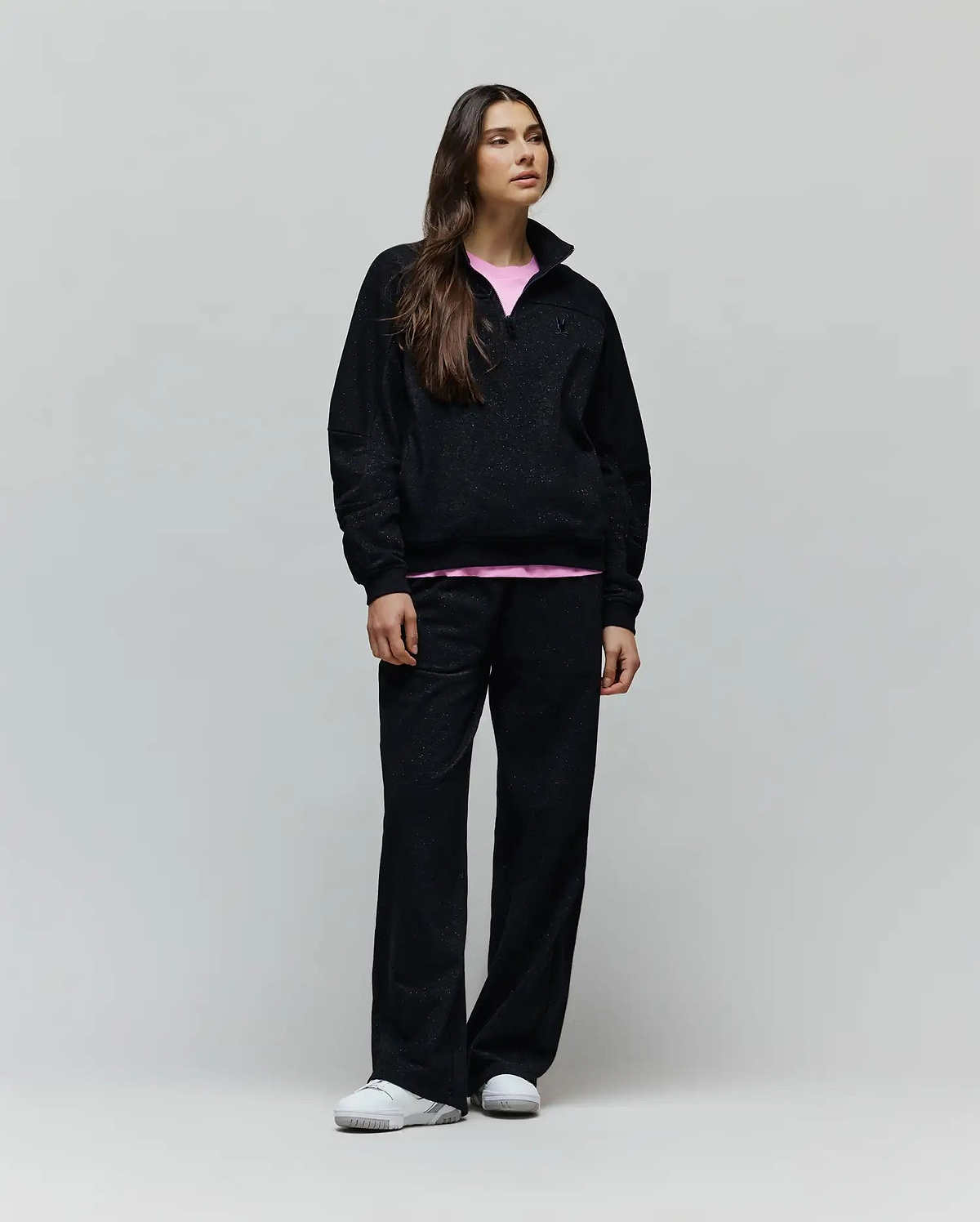 Womens Jules Lurex 1/4 Zip Pullover in black lurex knit, featuring a relaxed fit, small embroidered Psycho Bunny skull logo on the left chest, and a visible pink undershirt.