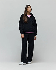Womens Jules Lurex 1/4 Zip Pullover in black lurex knit, featuring a relaxed fit, small embroidered Psycho Bunny skull logo on the left chest, and a visible pink undershirt.