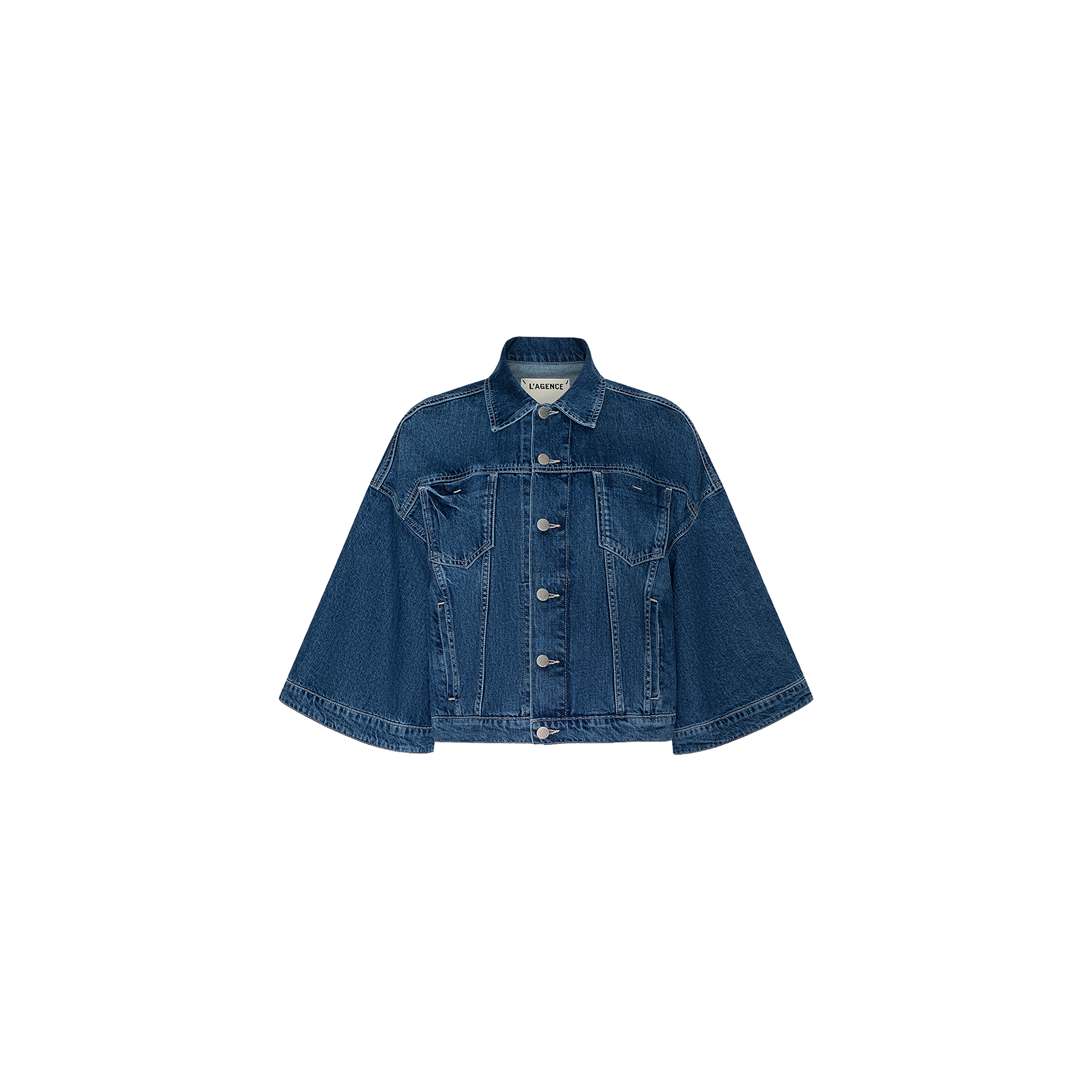 The Silas Cape Jacket is an all-cotton blue denim jean shirt jacket featuring cape sleeves, a front button closure, and two chest pockets, displayed on a plain white background.