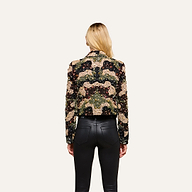 A woman with long blonde hair, seen from behind, wears the Jen Crystal Blazer and black leather pants, standing against a plain off-white background.