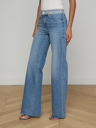 A person wearing the Louane Wide-Leg Flare Jean and a white top is standing against a plain white background.