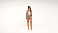 A woman wearing sunglasses, a taupe blazer and shorts set, a white top, and knee-high beige boots stands against a plain white background.
