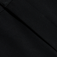 Close-up of black fabric with visible diagonal seams, showcasing the texture and stitching detail of the Colby Barrel-Leg Trouser.