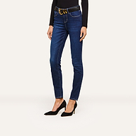 Person wearing dark blue skinny jeans with a black belt, paired with a fitted black long-sleeve top and black high-heeled shoes, standing against a plain white background. Face is not visible.