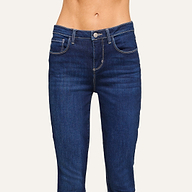A person wearing dark blue denim jeans stands against a light background. Their midsection and upper legs are visible, with hands and head out of frame. The jeans feature front pockets and contrast stitching.