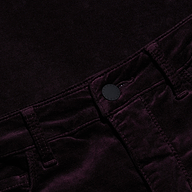 Close-up of the Stevie Velvet Jean, crafted from a soft, dark-colored velvety fabric, featuring a high-rise waistband, stitched belt loops, and a black front button.