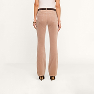 A person is shown from the back, wearing high-heeled shoes and the Stevie Velvet Jean in light brown, standing against a plain white background.