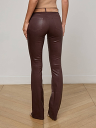 A person is shown from the back, standing against a plain light background, wearing the Selma Coated Bootcut Jean in a high-waisted, chocolate brown style.