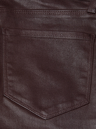 Close-up of the Selma Coated Bootcut Jean in chocolate brown denim, highlighting a stitched pocket with a pointed bottom and visible seam detailing along the edges.