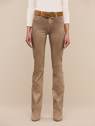 A person wearing the Selma Coated Bootcut Jean, styled with a brown belt and beige shoes, stands against a plain white background. Only the lower half of the body is visible.