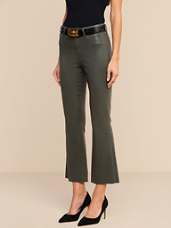 A person wearing the Kendra Coated Cropped Flare Jean in ash olive green, paired with a black sleeveless top, a black belt, and black high heels stands against a plain white background.