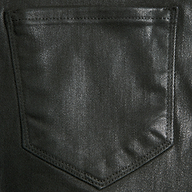 Close-up of the Kendra Coated Cropped Flare Jean’s back pocket in black, highlighting visible stitching and textured coated denim fabric, with a top opening and a tapered point at the bottom.