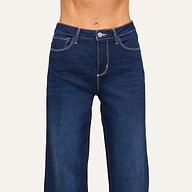 A person wearing high-waisted, dark blue jeans with white stitching is shown from waist to mid-thigh against a plain background.