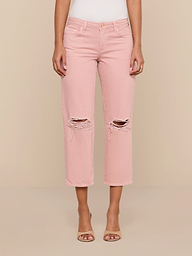 A person wearing the Blaine Cropped Stovepipe Jean in light pink with a ripped, low-rise, straight-leg fit and open-toed heels stands against a plain white background.