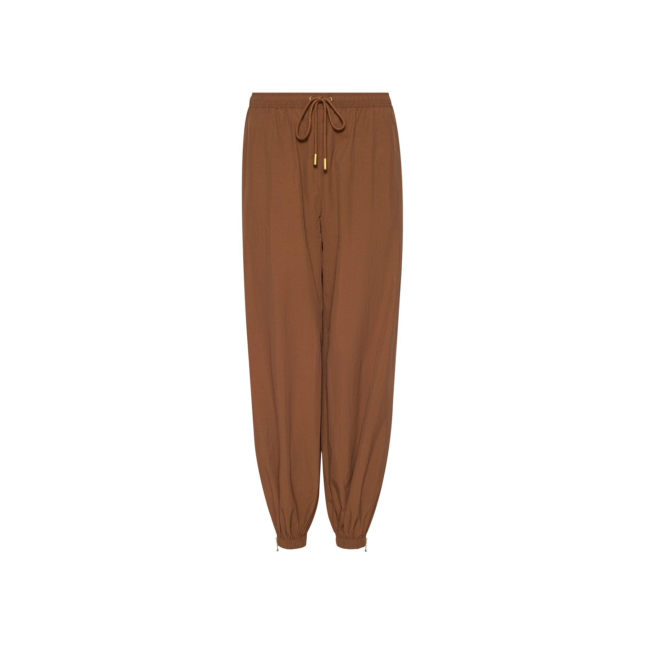 The Mariko Jogger, crafted from water-repellant nylon in brown, features a modern jogger silhouette with elastic cuffs, gold metal tips on the drawstrings, and a relaxed fit, displayed on a white background.