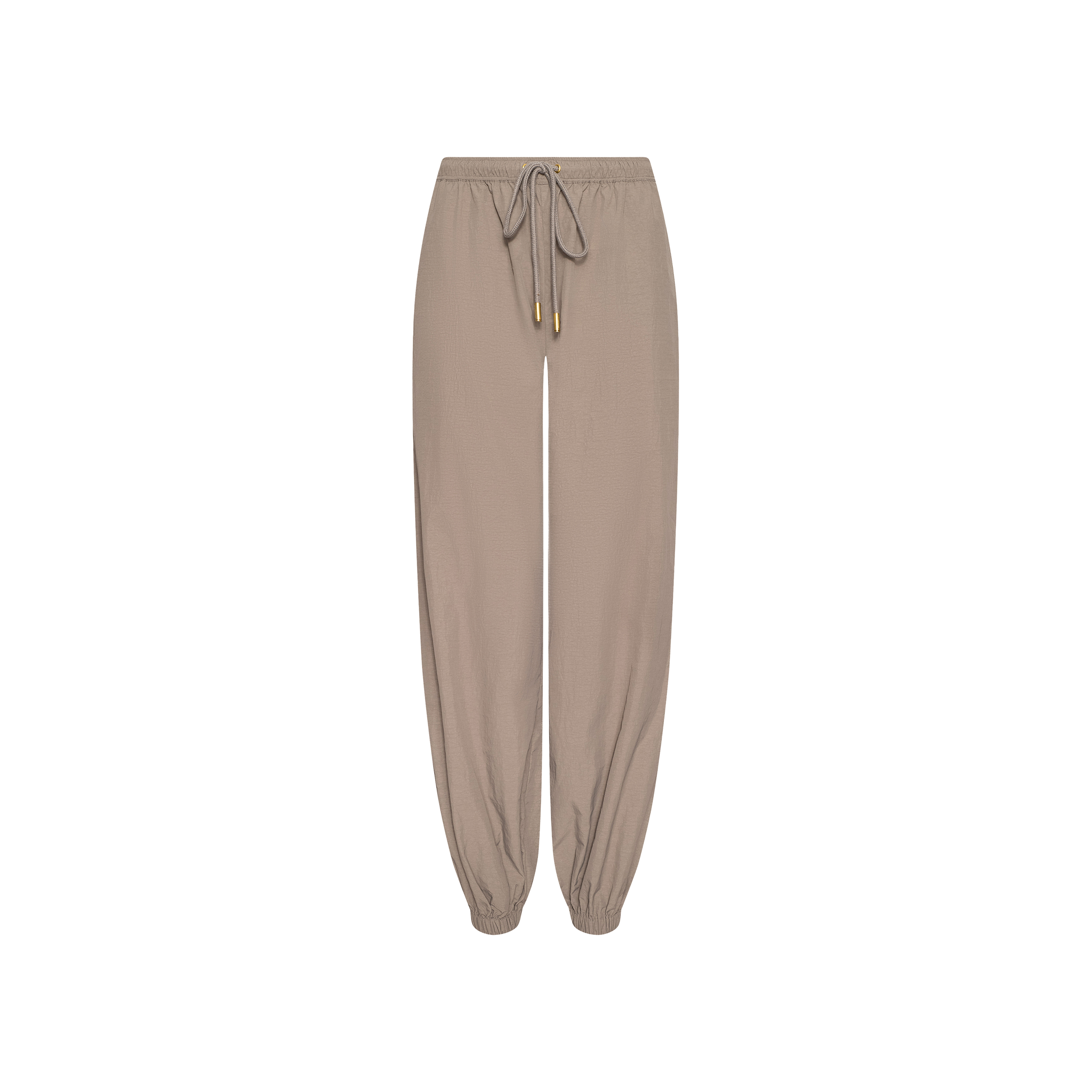 Mariko Jogger in light cardamom brown, crafted from water-repellent nylon, featuring an elastic waistband and cuffs with a front drawstring tie, displayed on a plain white background.