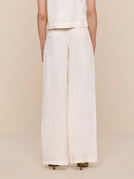 A person stands facing away, wearing the Amara Linen Wide-Leg Pant and a matching sleeveless top against a plain white background.