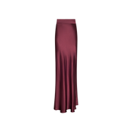 The Ryker Silk Maxi Skirt is a long, high-waisted maxi skirt in deep merlot red satin, featuring a bias cut and a slight flare at the hem, set against a white background.