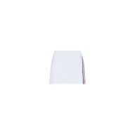 The Iga Tennis Skort is a white mini tennis skirt with a simple design, featuring a vertical red and navy blue stripe along one side, displayed against a plain white background.