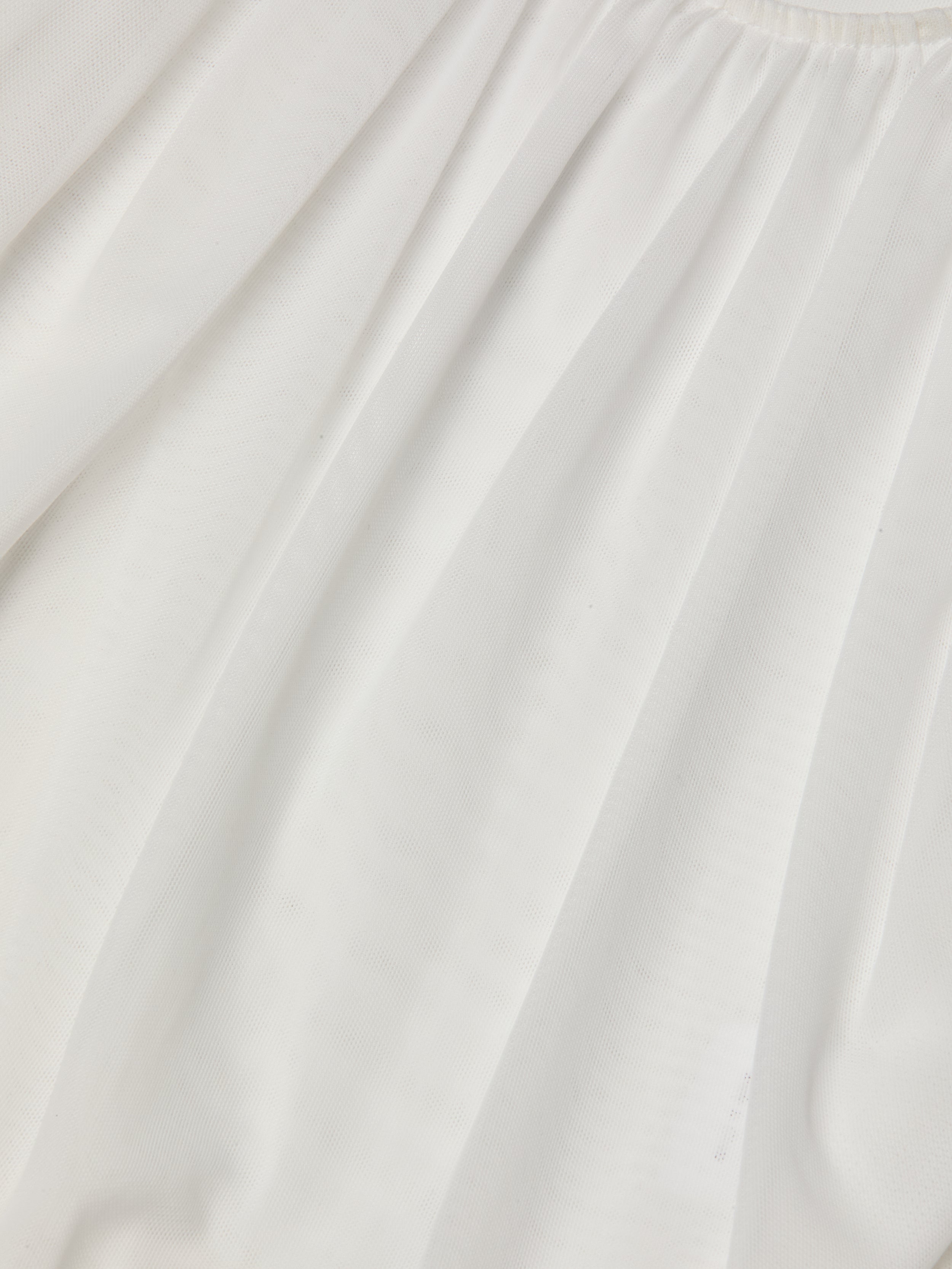 The Gelina Ruched Bodysuit features sheer white mesh with soft vertical ruching and a subtle textured finish for a delicate, airy look.