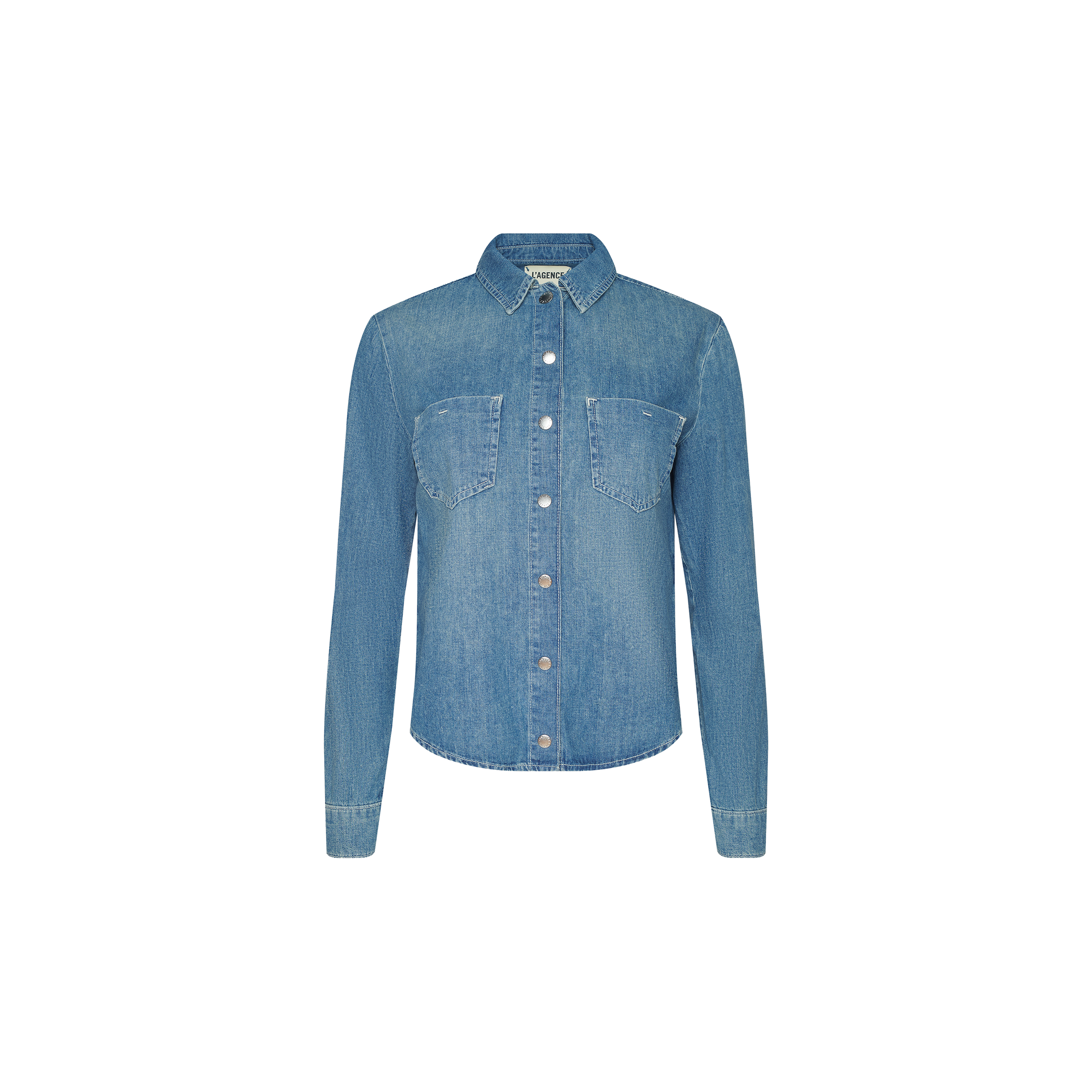 The Isla Shirt is a featherweight denim button-up in light blue, featuring long sleeves, two front chest pockets, and a pointed collar, displayed on a plain white background.