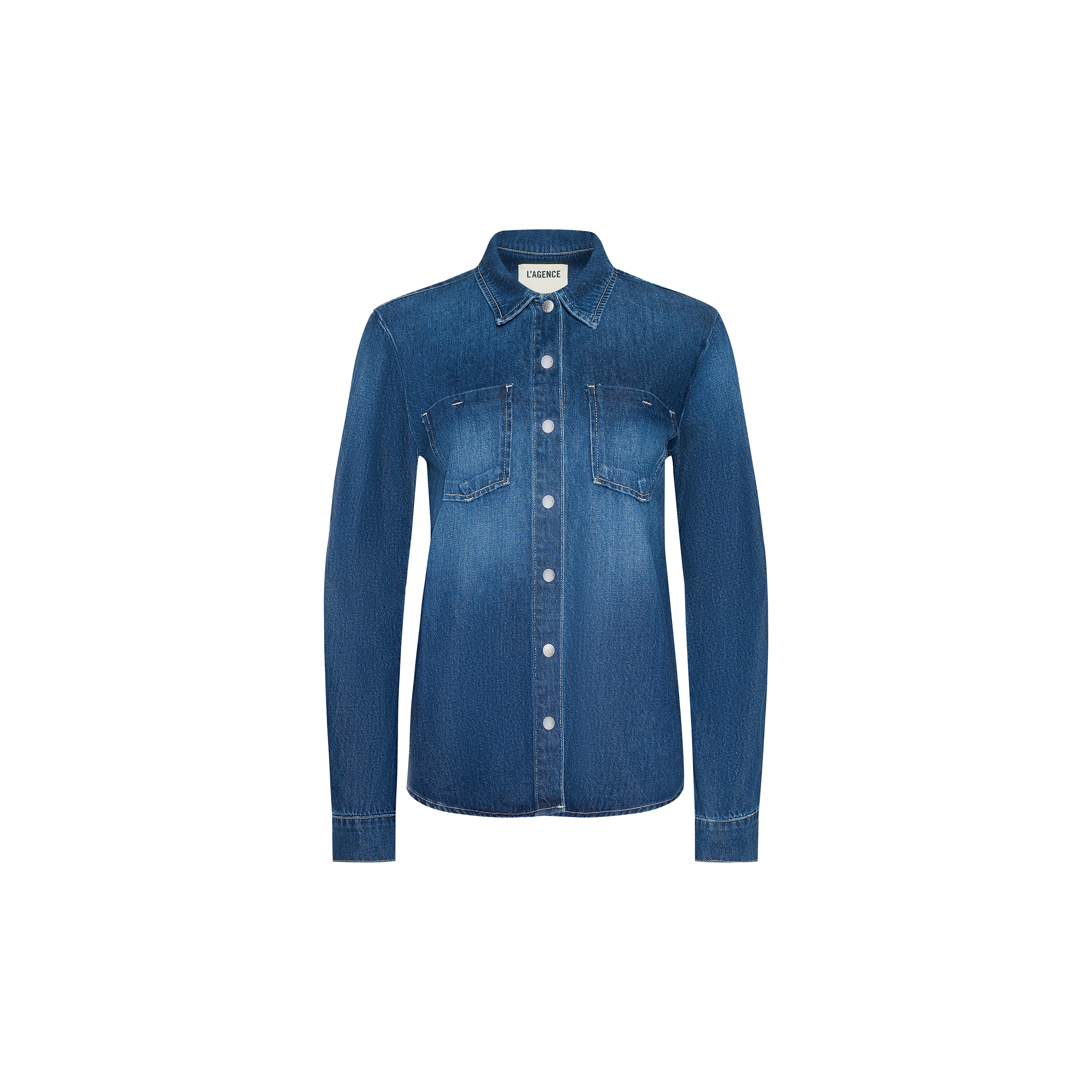 The Isla Shirt is a lightweight blue denim shirt featuring long sleeves, two chest pockets, and a classic collar, displayed on a plain white background.