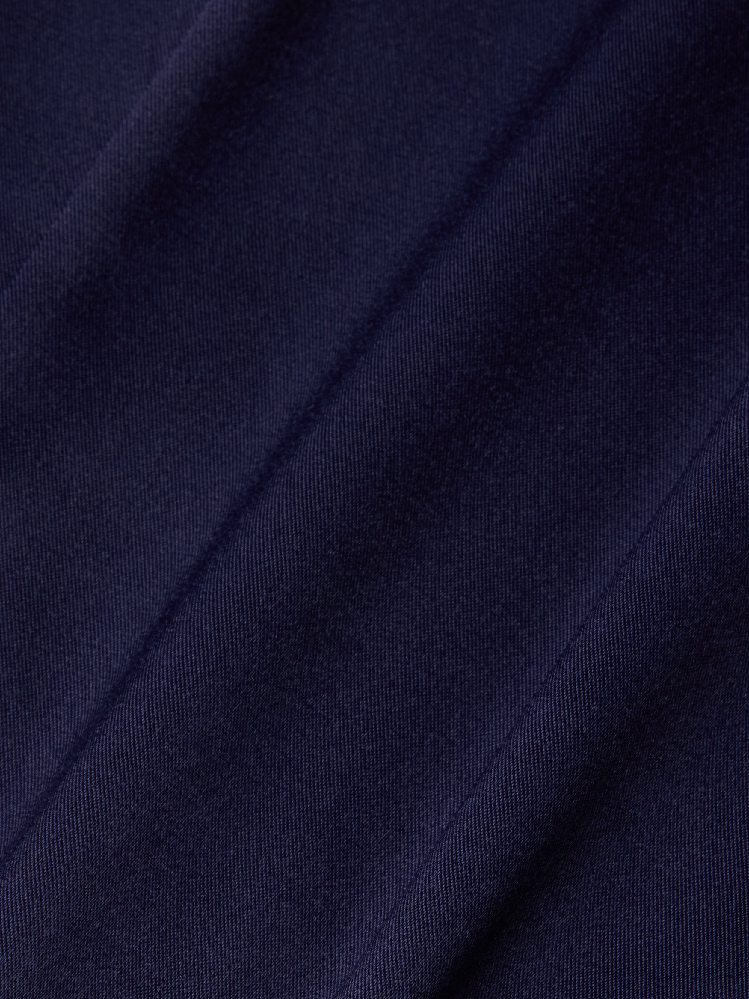 Close-up of the Dara Stretch-Satin Bodysuit in dark navy blue, featuring diagonal, slightly raised stripes that highlight its soft texture and subtle sheen—perfect for a bodysuit with adjustable straps.